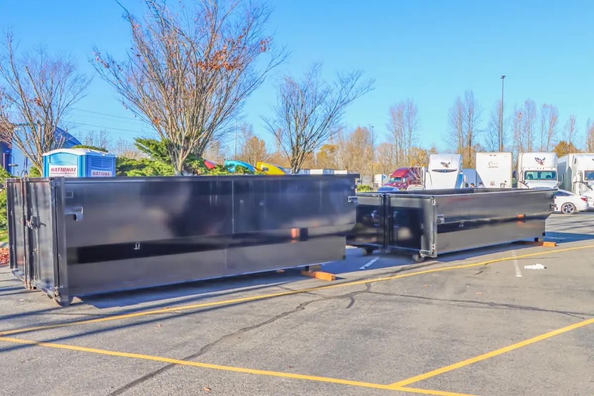 Professional dumpster rental service with roll-off container on residential driveway in Beekman